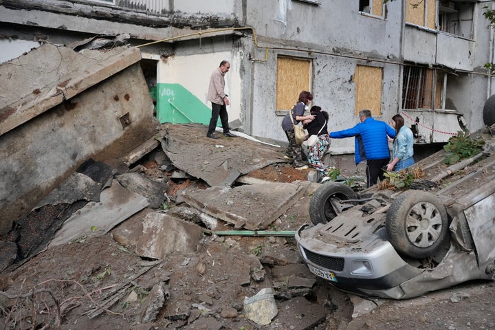 Local residents walk amid debris following a Russian missile attack in Kyiv, Ukraine, on July 6, 2026.