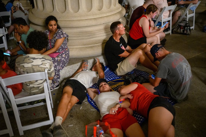People lie down under the National Archives building after being evacuated from the Great American State Fair on Saturday.