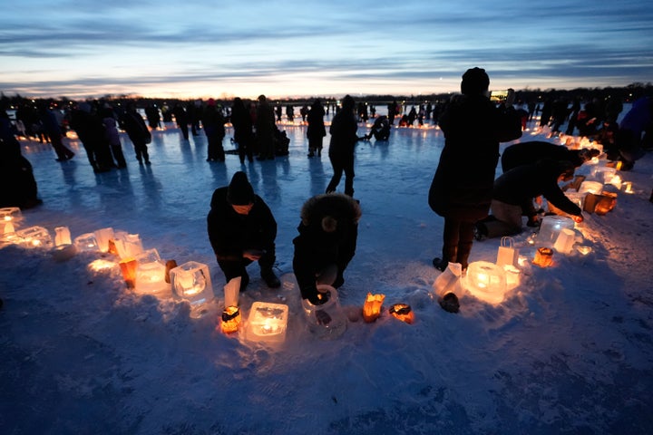 Activists gather in protest to light candles on frozen Lake Nokomis, spelling, "Ice Out" on Saturday, Jan. 31, 2026, in Minneapolis.