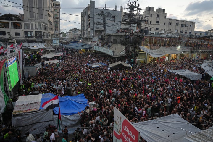Palestinians watch a live broadcast of the World Cup Round of 16 soccer match between Argentina and Egypt in Nuseirat, central Gaza Strip, on Tuesday.