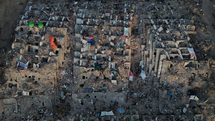 Relatives and search workers search through the rubble of buildings collapsed during the earthquakes in La Guaira, Venezuela, on Tuesday.