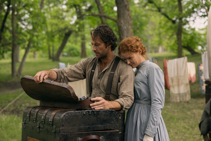 Luke Bracey as Charles Ingalls and Crosby Fitzgerald as Caroline Ingalls in Little House On The Prairie