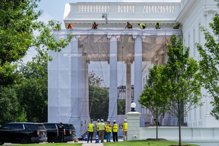Workers put up a tarp to cover the scaffolding on the North Portico of the White House, Thursday, July 9, 2026, in Washington. (AP Photo/Julia Demaree Nikhinson)