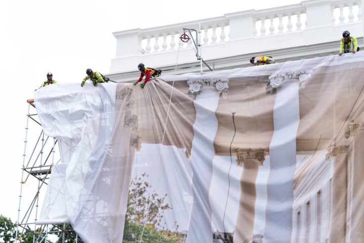 Workers cover the North Portico of the White House with tarp, Thursday, July 9, 2026, in Washington. (AP Photo/Manuel Balce Ceneta)
