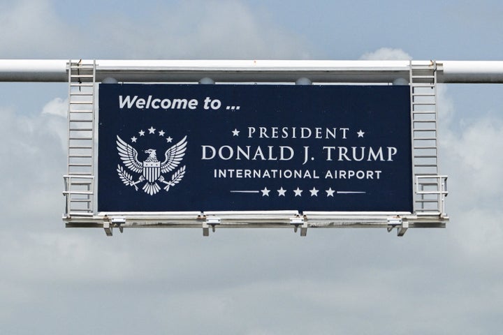 A new welcome sign reading "Donald J. Trump International Airport" is seen at the airport's main entrance ramp in West Palm Beach, Florida, on July 9, 2026. (Photo by CHANDAN KHANNA / AFP via Getty Images)