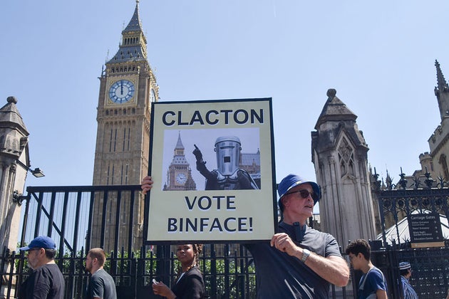 An activist holds a placard urging Clacton to vote for Count Binface.