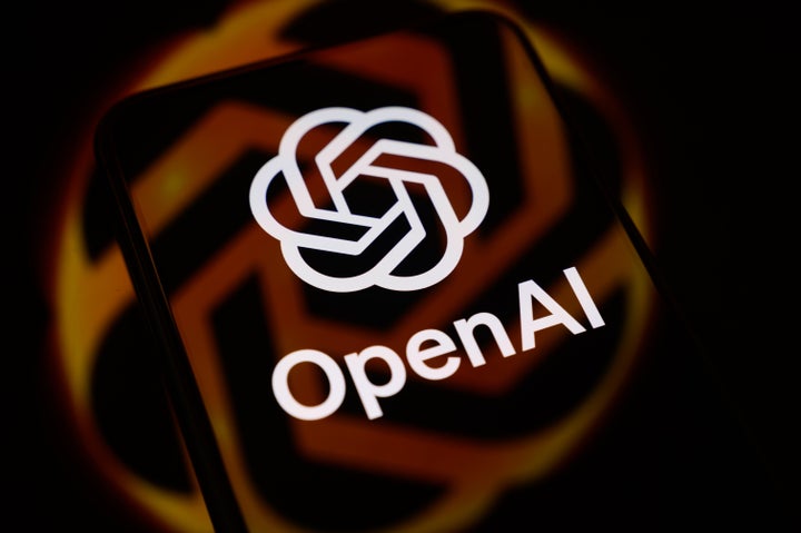 The OpenAI logo is displayed on a smartphone screen placed on a reflective surface onto which the company logo is projected, in Creteil, France, on June 29, 2026. (Photo by Samuel Boivin/NurPhoto via Getty Images)