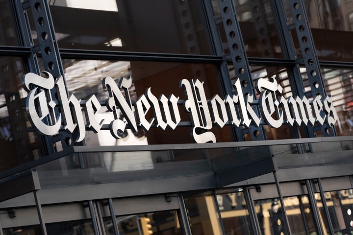A sign for The New York Times hangs above the entrance to its building, May 6, 2021, in New York. (AP Photo/Mark Lennihan, File)