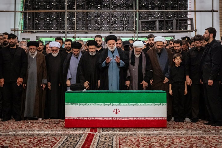 Mostafa Khamenei, center, brother of Iran's new Supreme Leader Mojtaba Khamenei, leads a prayer over the coffin of his late father, Iranian Supreme Leader Ayatollah Ali Khamenei before his burial at the Imam Reza Shrine in Mashhad, northeastern Iran, Thursday, July 9, 2026. (Office of the Iranian Supreme Leader via AP)