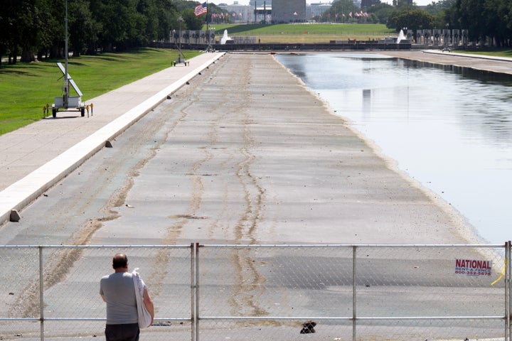 A person stops to look at the partially drained Lincoln Memorial Reflecting Pool on Monday in Washington, D.C.