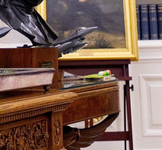 A zoomed-in version of the photo showing super glue on Trump’s desk.