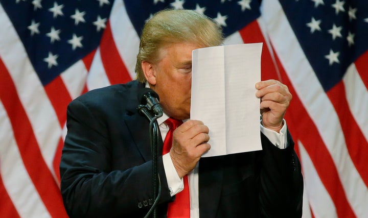 Donald Trump stares at a sheet of talking points and notes as he mocks critics who say he uses prepared speeches or teleprompters during a rally in Eugene, Oregon on May 6, 2016.