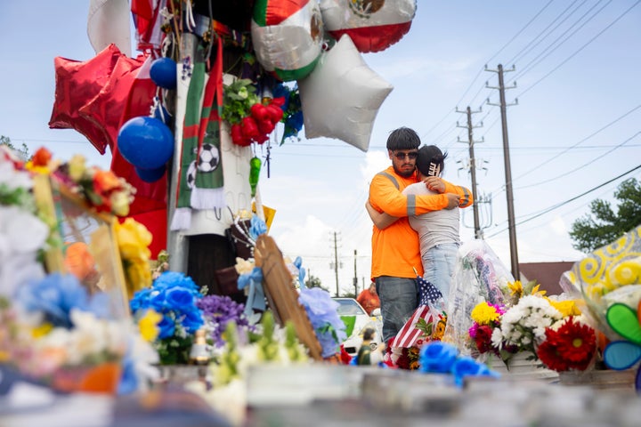 Albert Salgado is comforted by his girlfriend at the site where his uncle Lorenzo Salgado Araujo was shot by a federal immigration agent in Houston.
