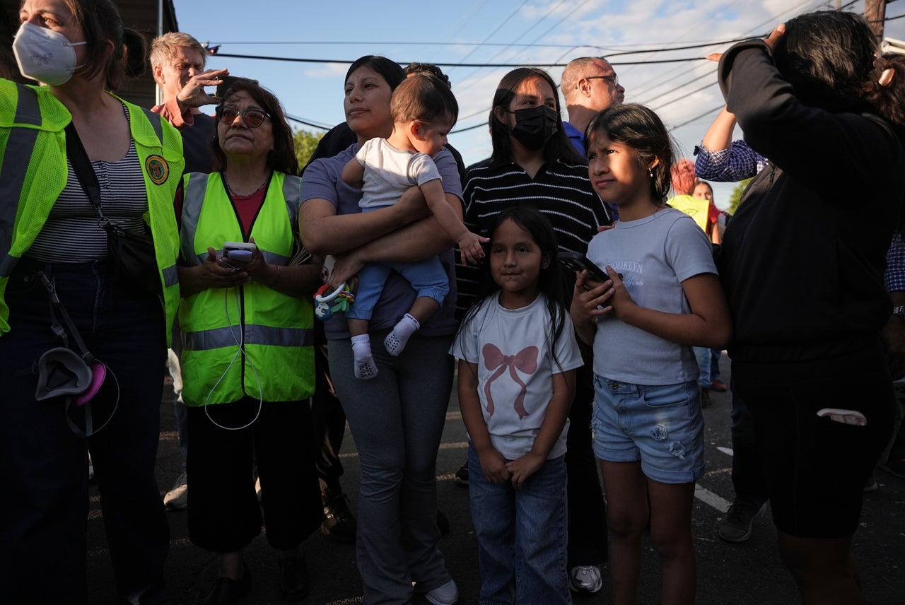 Family members wait for the release of another member as federal immigration officers confront protesters outside Delaney Hall detention center in May.