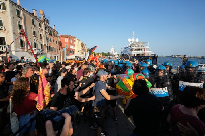 Protesters clash with police on a dock in Venice, Italy, near a U.S. envoy’s super yacht.