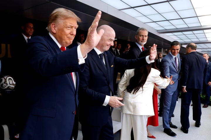 U.S. President Donald Trump waves at crowds with FIFA President Gianni Infantino during the FIFA World Cup 2026 Final on Sunday.