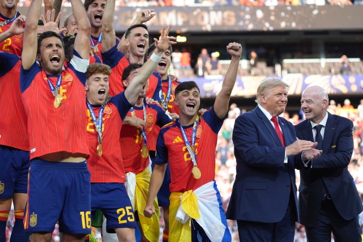 Spain players (left) cheer as FIFA President Gianni Infantino (right) gestures to U.S. President Donald Trump (second from right) at the conclusion of the World Cup final soccer match in East Rutherford, New Jersey, on Sunday. 