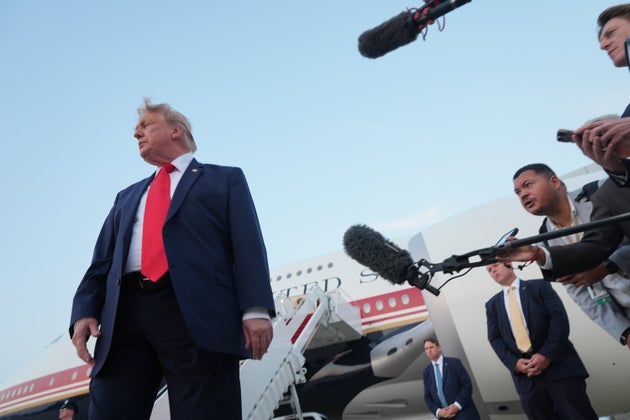 President Donald Trump speaks to reporters as he exits Air Force One at Joint Base Andrews, Md., after attending the World Cup final soccer match, Sunday, July 19, 2026. (AP Photo/Jacquelyn Martin)