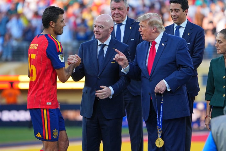 Spain’s Rodri is greeted by FIFA President Gianni Infantino and President Donald Trump during the World Cup final presentation ceremony.