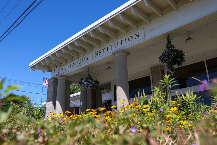 Flowers bloom outside the Chautauqua Institution welcome center in Chautauqua, N.Y., Friday, Aug. 12, 2022. (AP Photo/Joshua Bessex)