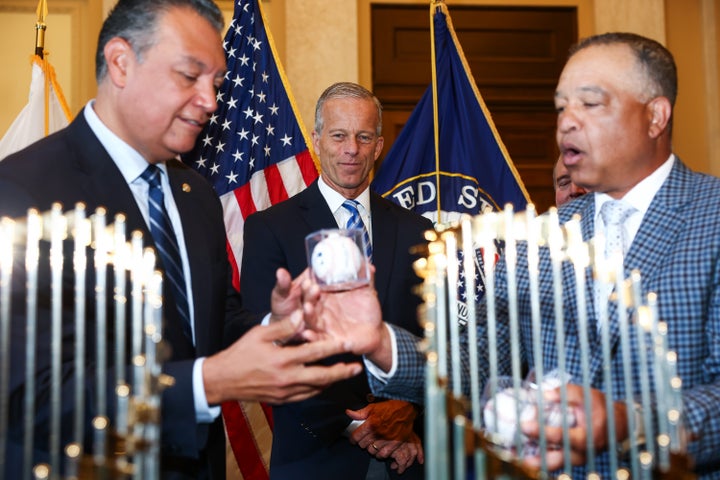 Sen. Alex Padilla (D-Calif, pictured on the left) is given a signed ball by Dodgers manager Dave Roberts on Thursday. Roberts met with Padilla and Sen. Adam Schiff (D-Calif.), both staunch Trump critics, along with a group of other legislators before the team’s trip to the White House.