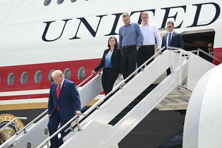 U.S. President Donald Trump disembarks from Air Force One with family members of Tyler Feehan, one of the servicemen repatriated to Dover, Delaware, earlier in the day upon arrival at Dobbins Air Reserve Base in Marietta, Georgia, July 22, 2026.