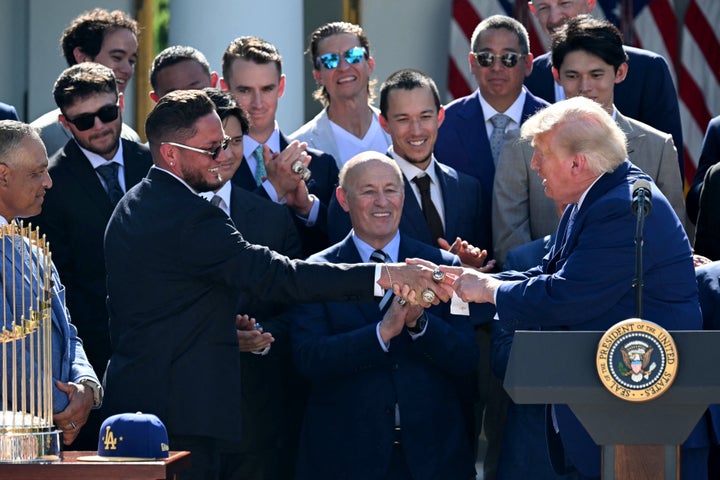Trump reaches out to Venezuelan shortstop Miguel Rojas, who he honored during his Rose Garden remarks on Thursday.