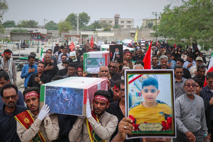 Mourners carry coffins containing additional remains of the victims identified through DNA testing during funerals in Minab, Iran, on Tuesday, July 22, 2026, nearly five months after Shajareh was killed in the February 28 attack on Tayyebeh School.(Razieh Poudat/ISNA via AP)