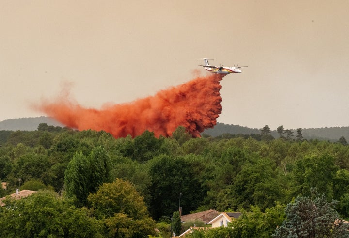 A water bomber drops water while fighting wildfires in the Lège-Cap-Ferret region, western France, on July 23, 2026.