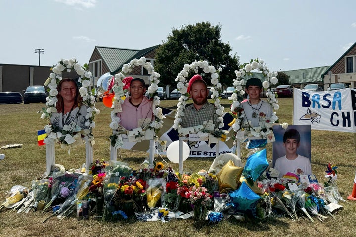 A poster with images of shooting victims from left, Cristina Irimie, Mason Schermerhorn, Richard Aspinwall and Christian Angulo is displayed at a memorial outside Apalachee High School, Sept. 10, 2024, in Winder, Ga.