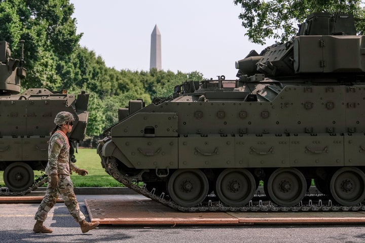 A U.S. Army soldier walks past a Bradley fighting vehicle staged in West Potomac Park ahead of an upcoming military parade commemorating the Army's 250th anniversary and coinciding with Donald Trump's 79th birthday, June 11, 2025, in Washington. (AP Photo/Julia Demaree Nikhinson, File)