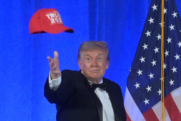 President Donald Trump tosses a "Trump 2028" hat at the White House Correspondents' Association dinner at the Waldorf Astoria Washington DC, Friday, July 24, 2026, in Washington. (AP Photo/Rod Lamkey, Jr.)
