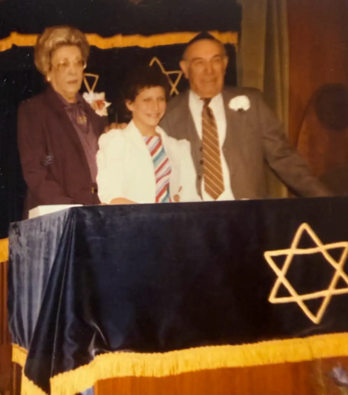 The author, age 13, at their bat mitzvah, with their grandparents, Esther and Willie.