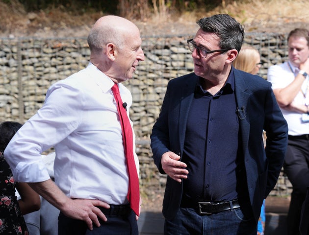 Britain's Prime Minister Andy Burnham speaks with Britain's Chancellor of the Exchequer John Healey during a visit to a family centre in Sheffield, northern England, on July 31, 2026, where he announced his government would give Mayors of city regions in England a share of income tax and business rate revenues. 
