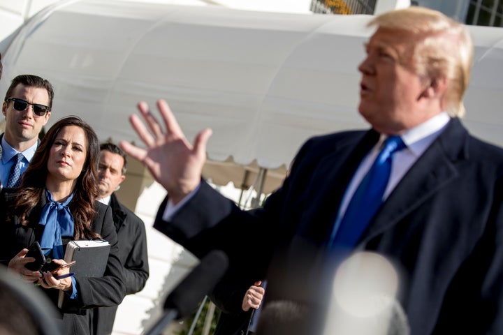 White House press secretary Stephanie Grisham listens as President Donald Trump, speaks to reporters on the South Lawn of the White House in Washington, Friday, Nov. 8, 2019, before boarding Marine One. (AP Photo/Andrew Harnik)