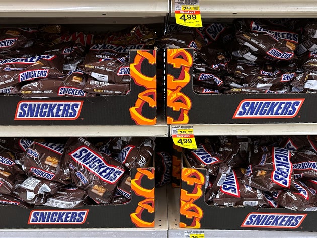 Snickers chocolate bars are displayed on shelves at a grocery store in Mount Prospect, Ill., Monday, Oct. 20, 2025. (AP Photo/Nam Y. Huh)