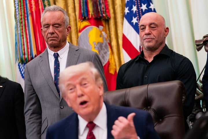 Secretary of Health and Human Services Robert F. Kennedy Jr. (left) and Rogan stand behind President Donald Trump at an executive order signing regarding psychedelics in the Oval Office of the White House in Washington, D.C., in April.