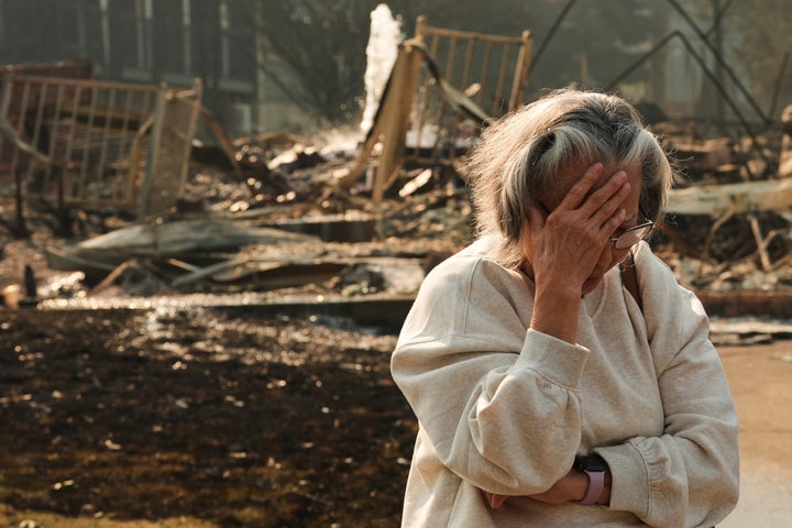 Spokane resident Miriam Sim, 76, reacts while talking about her neighborhood after it largely burned to the ground in a wildfire on Aug. 3, 2026.