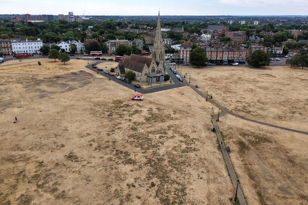 Dried vegetation is seen surrounding the All Saints church in Blackheath, London, Tuesday, Aug. 4, 2026, as the hot and very dry weather continues for most parts of the UK.
