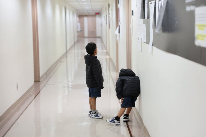 Children wait outside of an immigration court at the Jacob K. Javits Federal Building on July 31, 2026 in New York City. More than 1,400 migrant children across New York, including more than 700 in New York City, are set to lose legal representation as a $200 million federal contract with the Acacia Center for Justice expires. The nonprofit oversees legal services for unaccompanied migrant children and estimates the funding loss will affect more than 24,000 children nationwide.