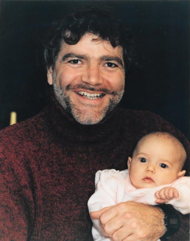The author's father holding her as a baby