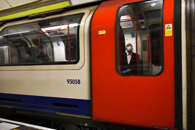 A man sits on a London underground train as he wears a protective mask, in London, Tuesday, May 12, 2020. Britain's Prime Minister Boris Johnson announced on Sunday, limited changes to the national lockdown.(AP Photo/Alberto Pezzali)
