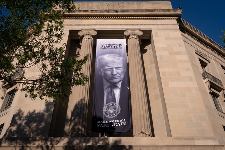 A giant portrait of President Donald Trump looks down from the Justice Department in Washington.