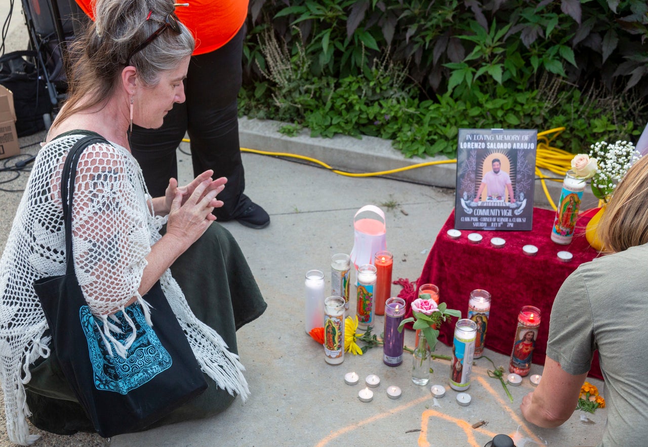 A woman prays at a makeshift altar during a vigil in the Mexican American neighborhood of Detroit honoring Lorenzo Salgado Araujo, who was shot and killed by ICE agents in Houston on July 7. Salgado Araujo had been in the United States for 35 years and was the father of three.