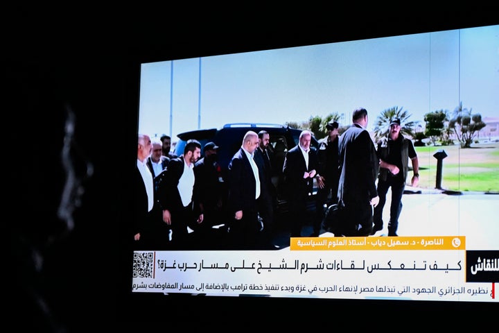 An Egyptian woman watches the news on a local channel in Cairo on Oct. 8, 2025, showing images of top Hamas negotiator Khalil al-Hayya (C) arriving in Sharm El-Sheikh for talks on ending Israel’s destruction of Gaza. Al-Hayya led a delegation for another round of ceasefire talks in Cairo to try and implement the Trump administration’s peace plan in Gaa, Egyptian media reported on Aug. 16, 2026.