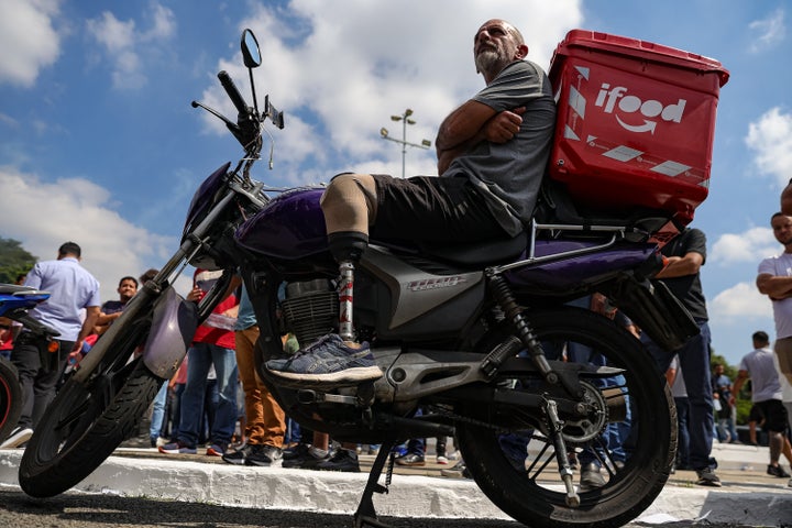 Ride-hailing and delivery app drivers, including Uber and 99 workers, participate in a protest against a bill regulating working conditions in the gig economy at Charles Miller Square in Sao Paulo, Brazil, on April 14, 2026.