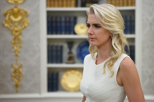White House aide Natalie Harp has been a constant, yet quiet, blond presence in Trump 2.0. Here she looks on as Trump signs an executive order about quantum computing in June.