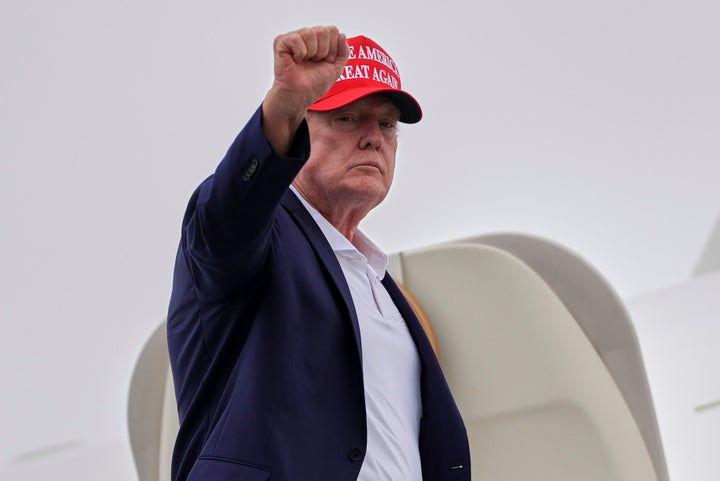 President Donald Trump throws up his fist as he boards Air Force One at New Jersey’s Morristown Airport on Sunday, Aug. 16. (AP Photo/Julia Demaree Nikhinson)