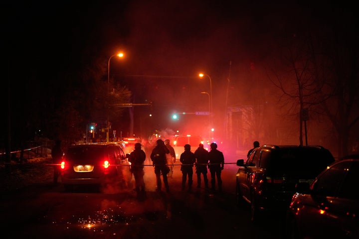 Tear gas surrounds federal law enforcement officers following a shooting on Jan. 14, 2026, in Minneapolis.