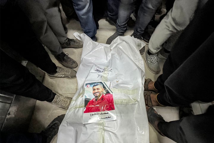 People gather around the shrouded body of Palestinian paramedic Mohamed Bahloul, who was killed with 14 other first responders with the Red Crescent a week earlier in Israeli military fire on ambulances, at Nasser Medical Complex in Gaza’s Khan Younis on March 30, 2025. The Israeli military announced on Aug. 19, 2026 that it’s launching criminal investigations into the killings of 5-year-old Hind Rajab and of the paramedics, in what would be the first criminal probe into troop conduct in Gaza.